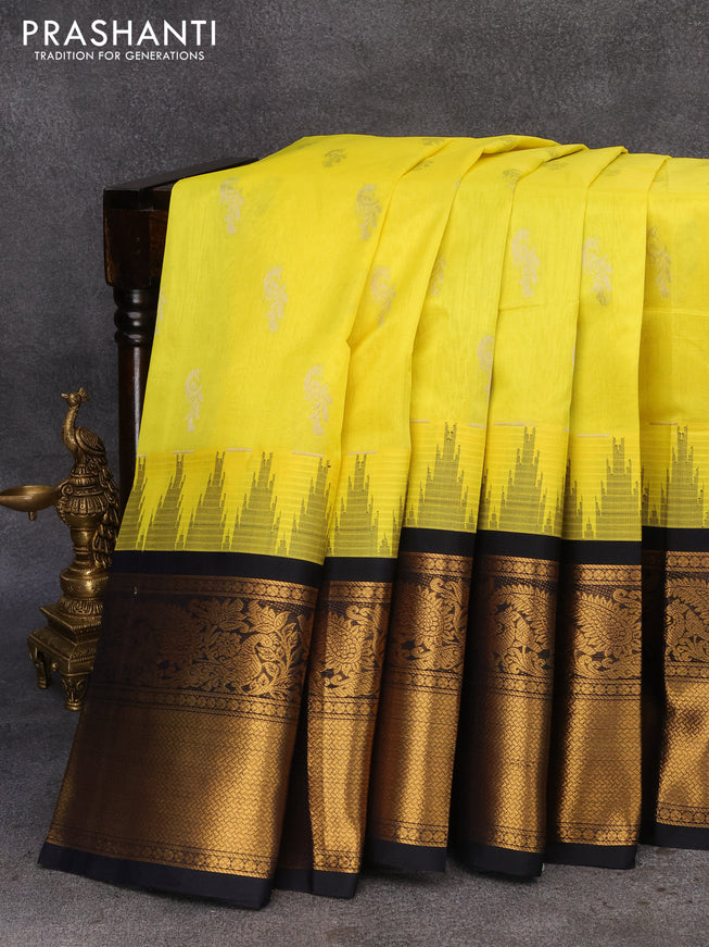 Kuppadam silk cotton saree lime yellow and navy blue with silver zari woven buttas and temple design long zari woven border