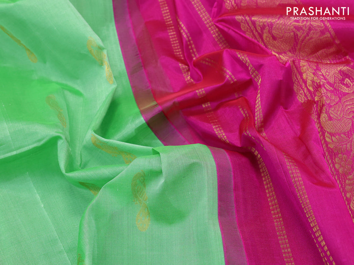 Silk cotton saree light green and pink with peacock zari woven buttas and zari woven korvai border