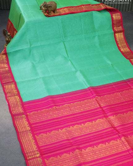 Silk cotton saree green and pink with plain body and zari woven korvai border