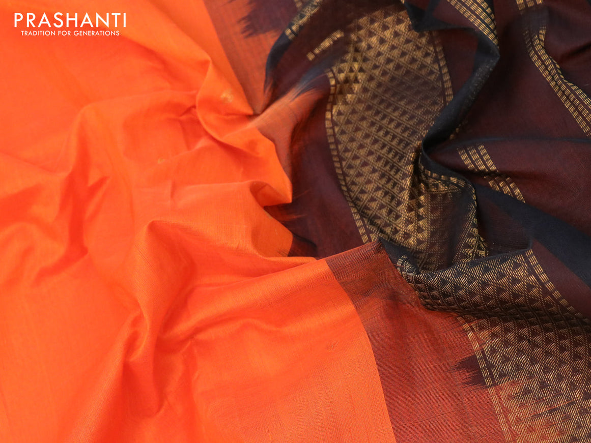 Silk cotton saree orange and black with plain body and zari woven korvai border