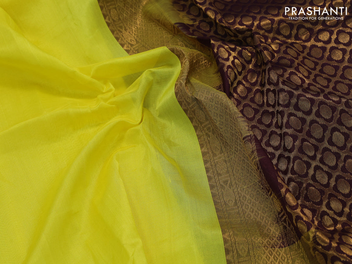 Silk cotton saree lime yellow and wine shade with plain body and zari woven korvai border