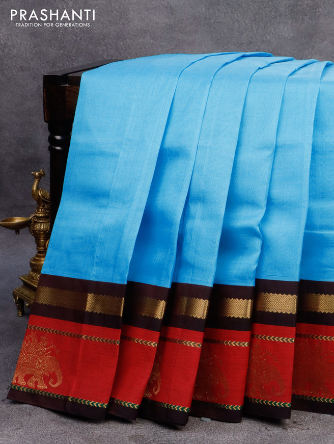 Silk cotton saree light blue and coffee brown with plain body and zari woven butta korvai boder