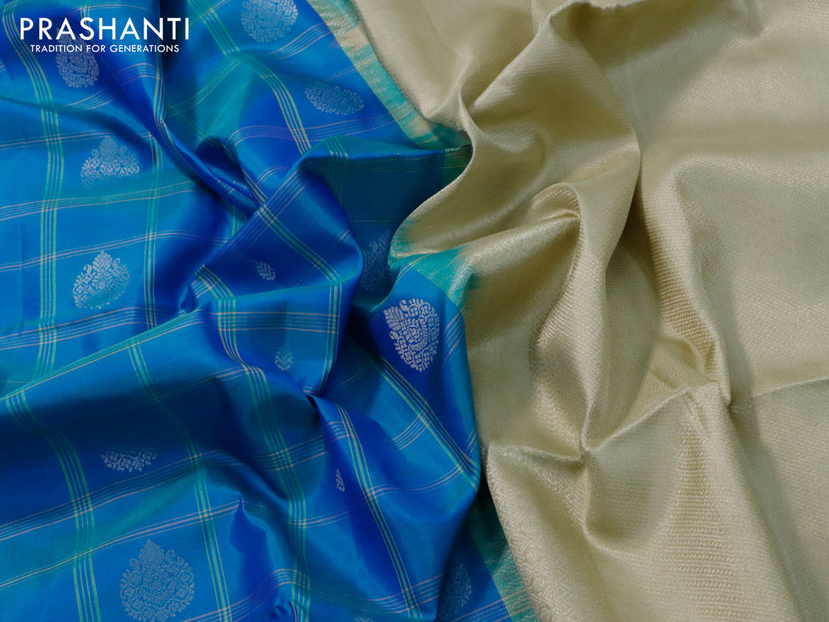 Pure soft silk saree dual shade of blue and elaichi green with allover checks & silver zari buttas and zari woven border