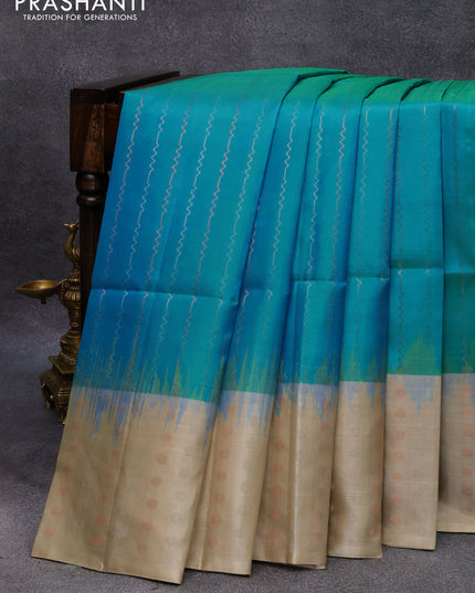 Pure soft silk saree dual shade of blue and beige with allover silver & copper zari weaves and long silver & copper zari woven butta border