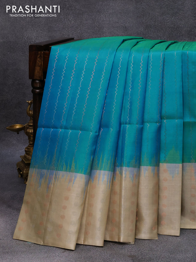 Pure soft silk saree dual shade of blue and beige with allover silver & copper zari weaves and long silver & copper zari woven butta border