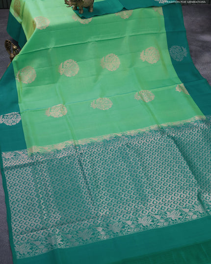 Roopam silk saree dual shade of green and teal green with copper zari woven floral buttas and copper zari woven butta border