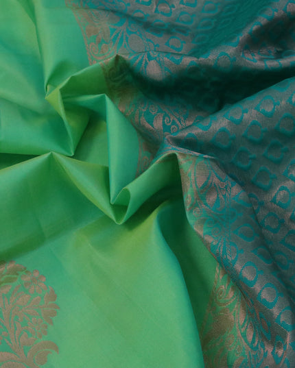 Roopam silk saree dual shade of green and teal green with copper zari woven floral buttas and copper zari woven butta border