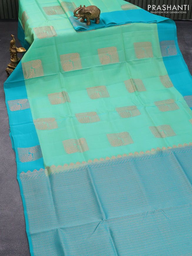Roopam silk saree dual shadeof teal green and teal blue with copper zari woven buttas and copper zari woven butta border