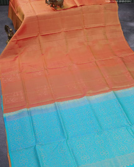 Roopam silk saree dual shade of yellowish pink and dual shade of teal blue with copper zari woven buttas in borderless style