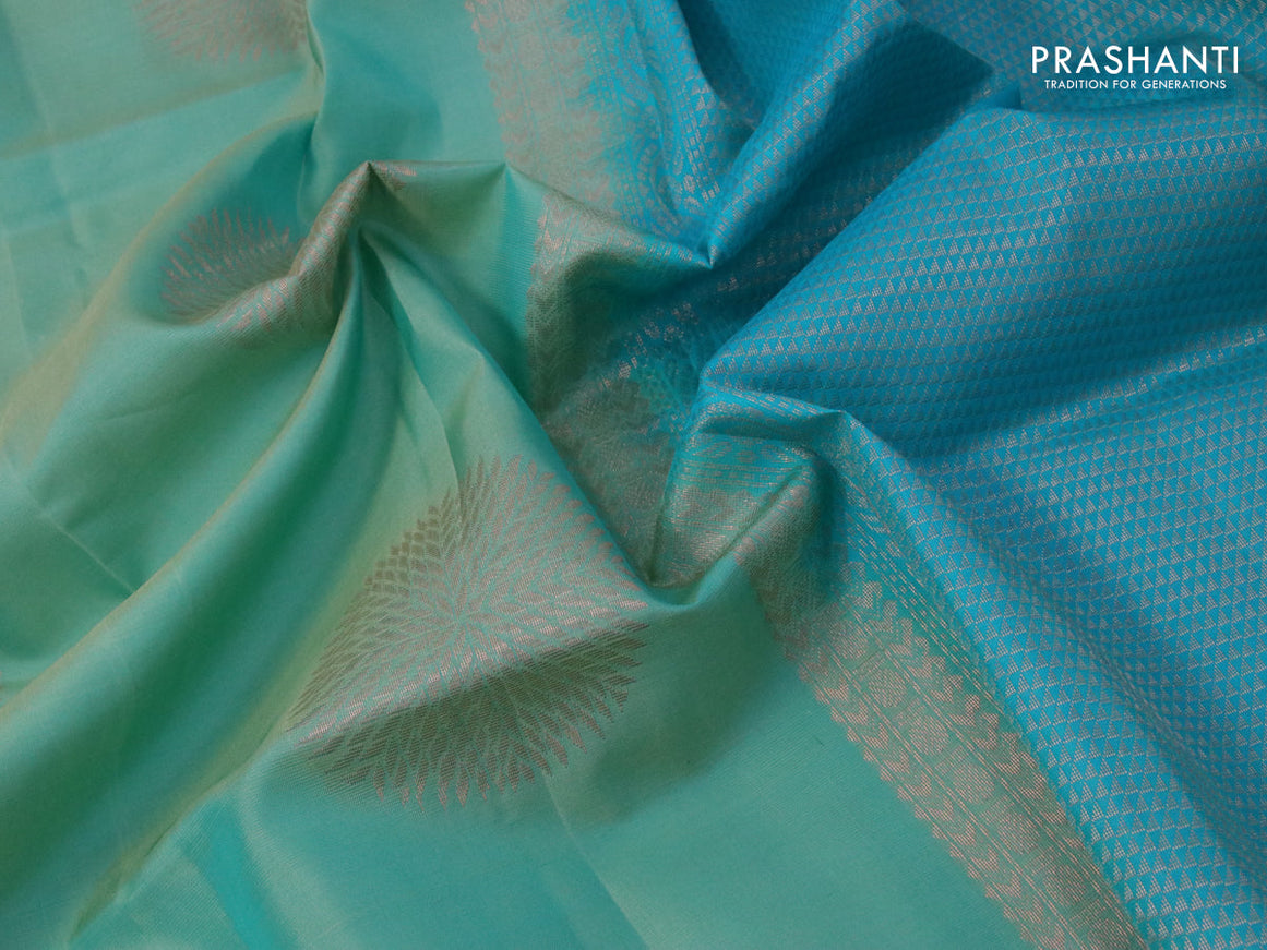 Roopam silk saree dual shade of pastel green and blue with copper zari woven buttas and copper zari woven butta border