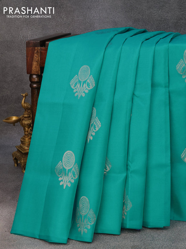 Roopam silk saree teal blue and blue with copper zari woven buttas in borderless style