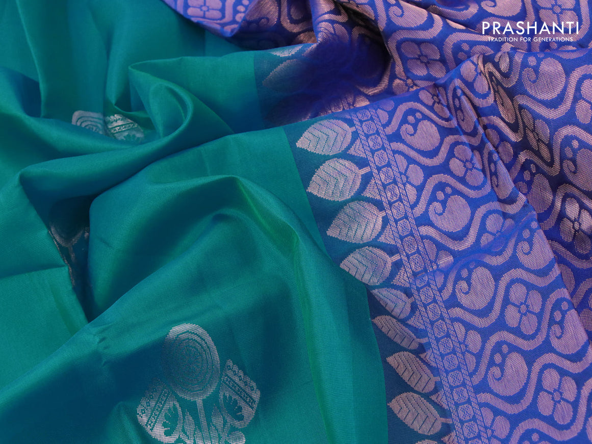 Roopam silk saree dual shade of teal blue and blue with copper zari woven floral buttas in borderless style