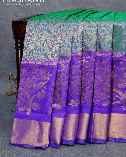 Pure uppada silk saree dual shade of greenish blue and royal blue with allover peacock zari woven brocade weaves and long floral design zari woven border