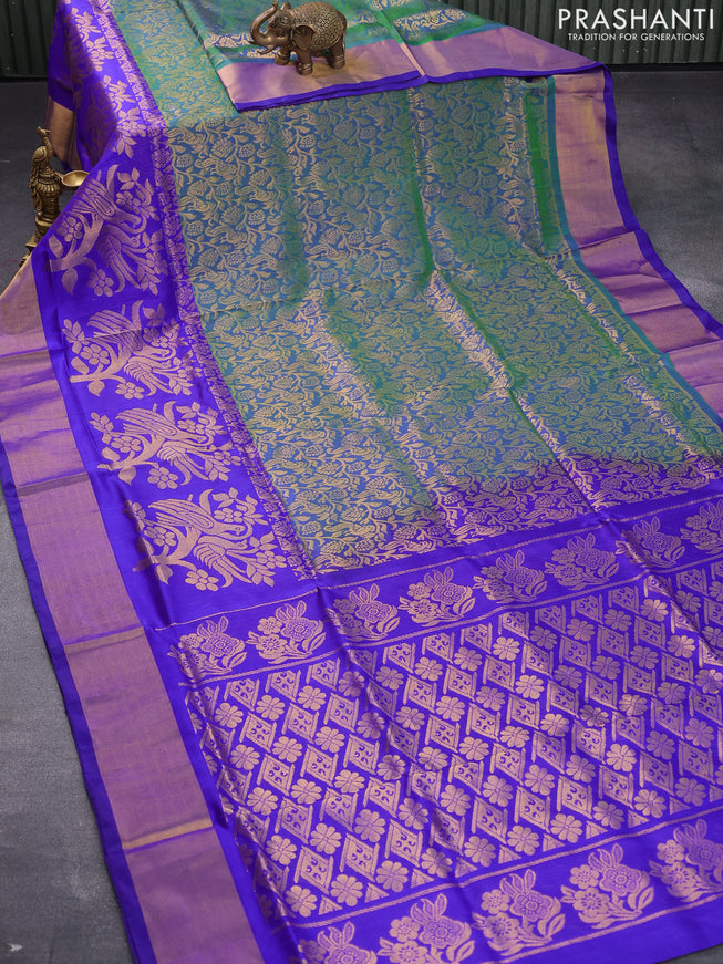 Pure uppada silk saree dual shade of greenish blue and royal blue with allover peacock zari woven brocade weaves and long floral design zari woven border