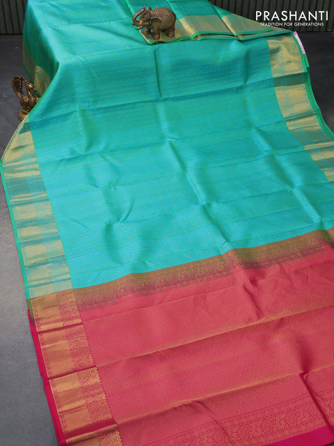 Pure kanjivaram silk saree dual shade of teal bluish green and pink with allover self emboss & zari buttas and paisley zari woven border