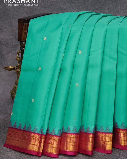 Pure kanjivaram silk saree teal blue and dark magenta pink with zari woven buttas and zari woven korvai border