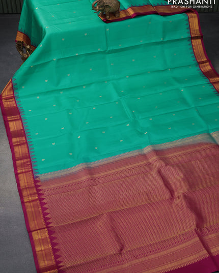 Pure kanjivaram silk saree teal blue and dark magenta pink with zari woven buttas and zari woven korvai border