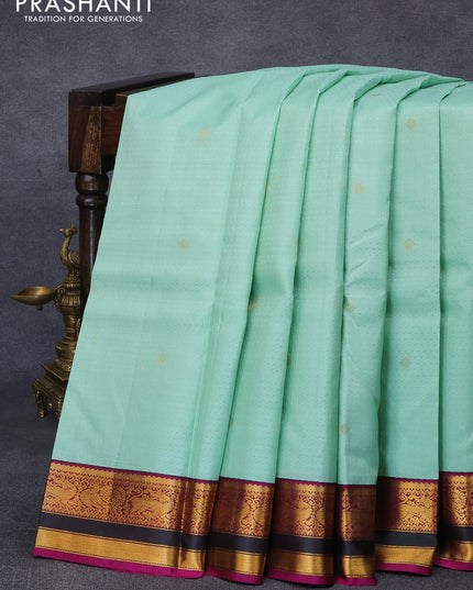 Pure kanjivaram silk saree pastel green and purple with allover self emboss & zari buttas ad zari woven korvai border
