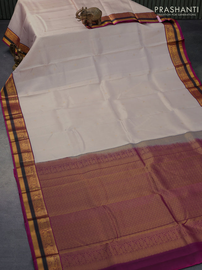 Pure kanjivaram silk saree cream and purple with allover self emboss ad zari woven korvai border
