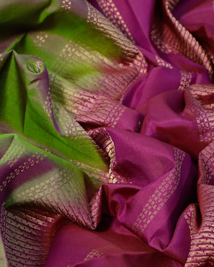 Pure kanjivaram silk saree dual shade of green and purple with allover zari weaves and zari woven border