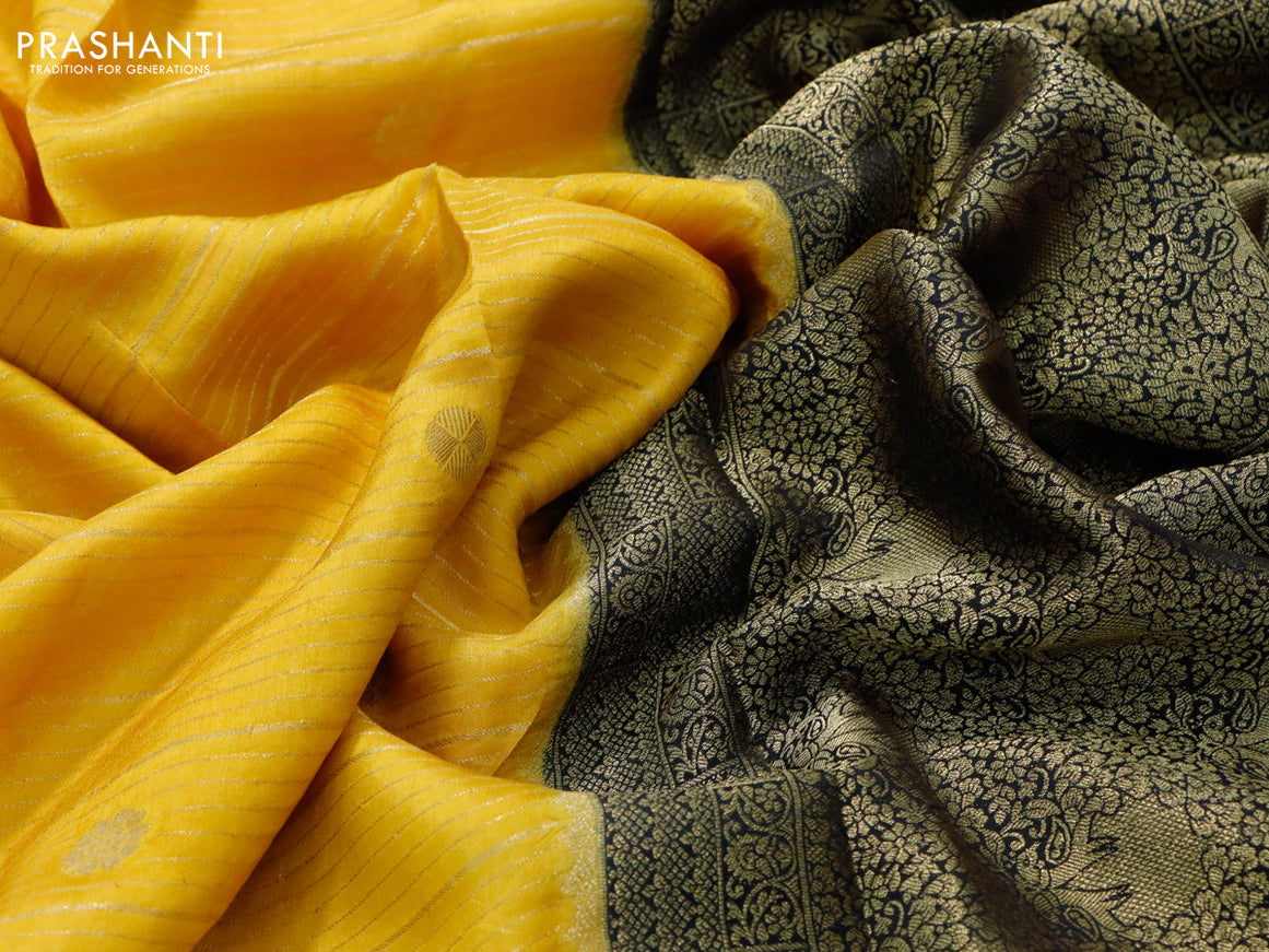 Dola silk saree yellow and dark green with allover zari stripes & butta weaves and zari woven border & zari butta blouse