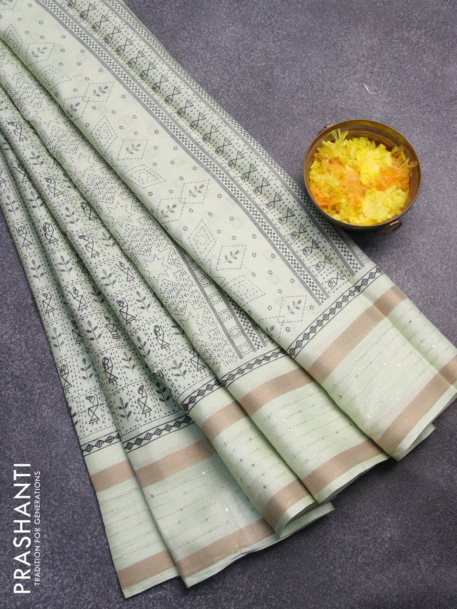 Semi dola saree pista green with allover warli prints and zari woven sequin work border