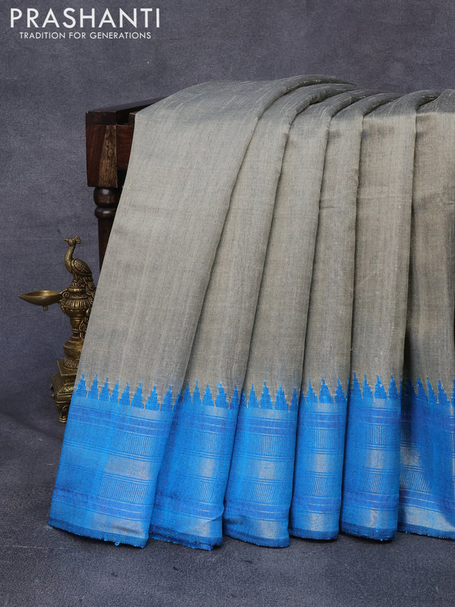 Dupion silk saree beige and cs blue with plain body and temple design zari woven border