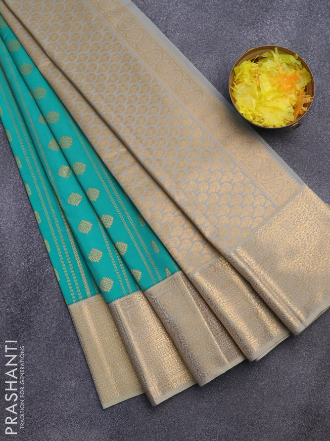 Semi kanjivaram silk saree teal blue and dual shade of greyish beige with allover zari weaves and zari woven korvai border