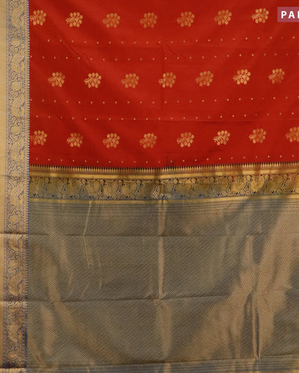 Semi kanjivaram silk saree rust shade and cs blue with zari woven floral buttas and long zari woven korvai border