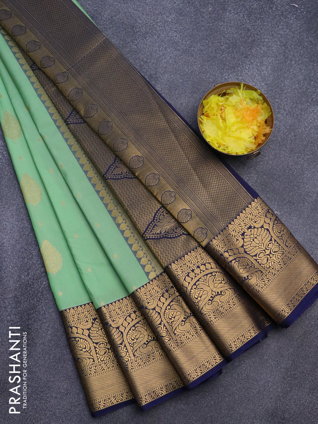 Semi kanjivaram silk saree teal green shade and navy blue with zari woven buttas and zari woven korvai border