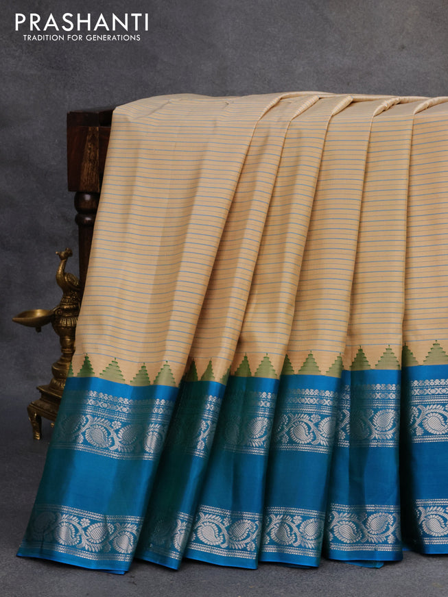 Pure gadwal silk saree sandal and cs blue with allover stripes pattern and rettapet silver zari woven border