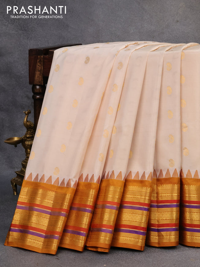Pure gadwal silk saree cream and mustard shade with zari woven paisley buttas and temple design zari woven border