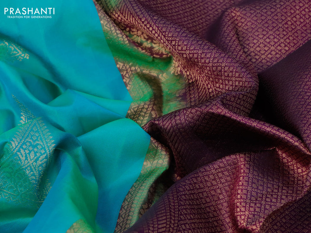 Pure kanjivaram silk saree dual shade of teal bluish green and purple with zari woven geometric buttas and simple border
