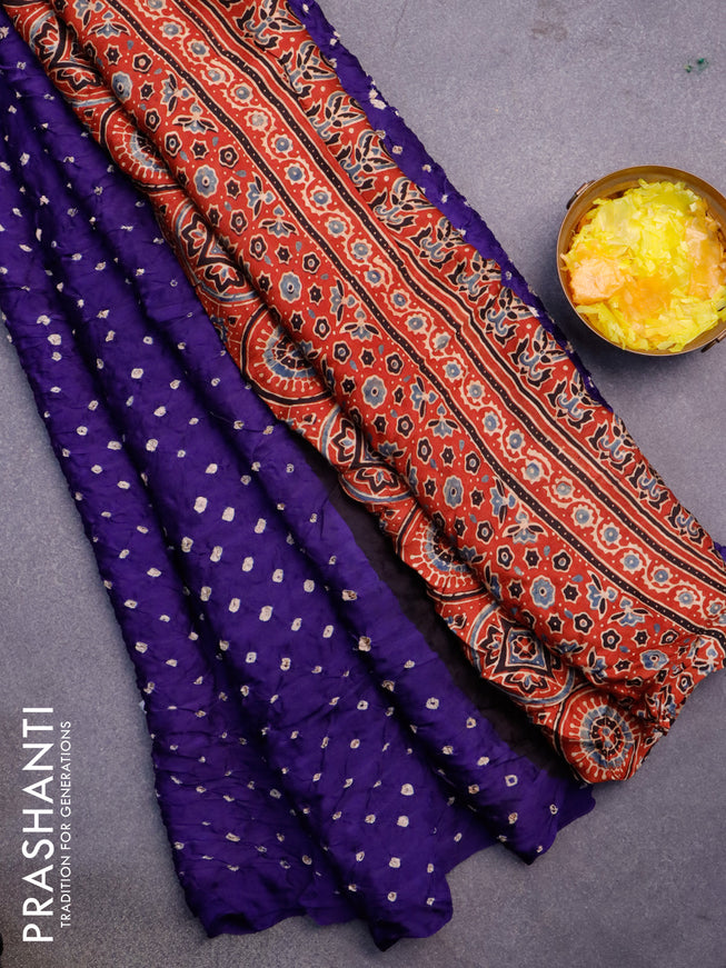 Modal silk saree violet and rust shade with allover bandhani prints and ajrakh printed pallu