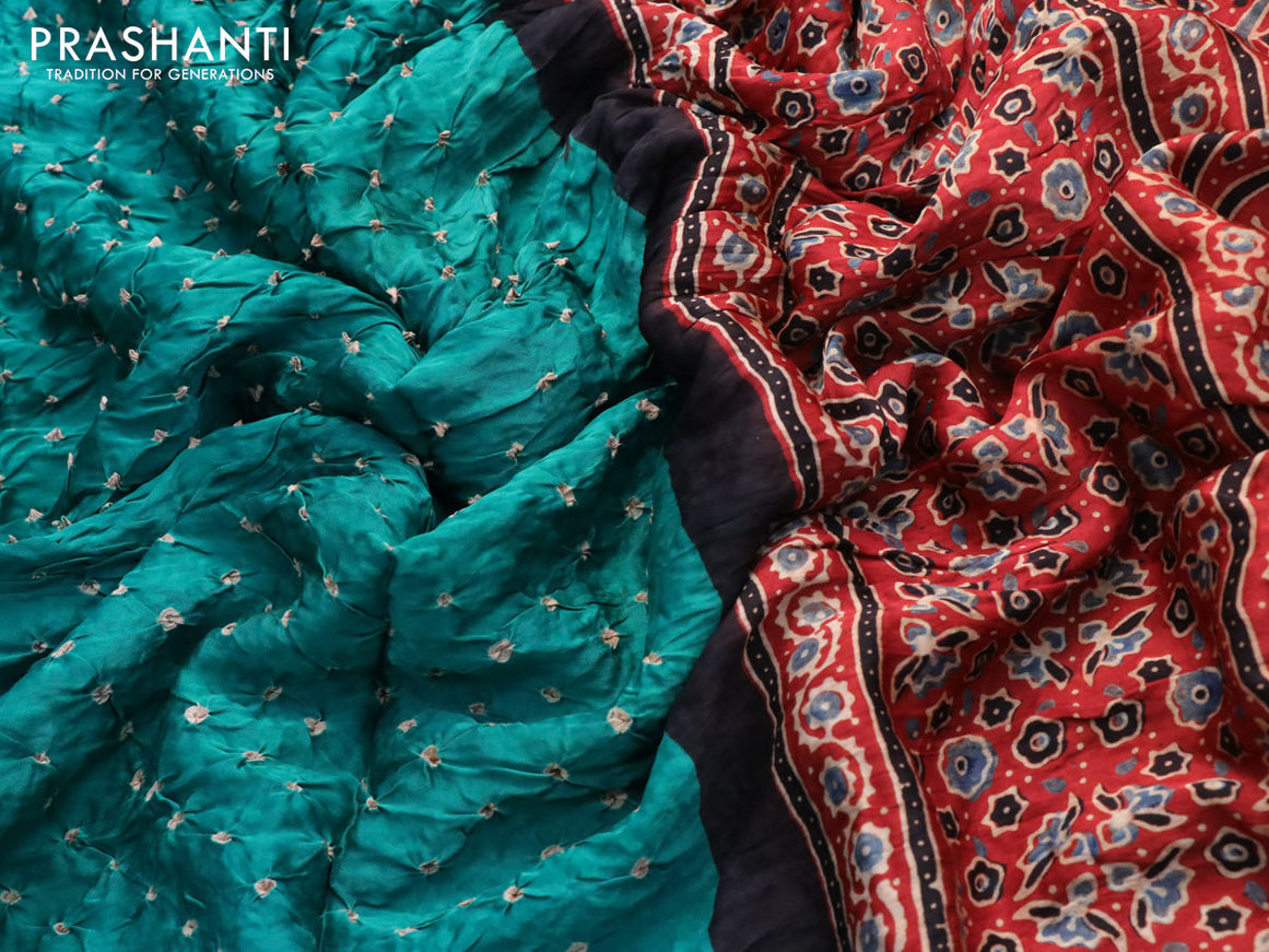 Modal silk saree teal green and rust shade with allover bandhani prints and ajrakh printed pallu
