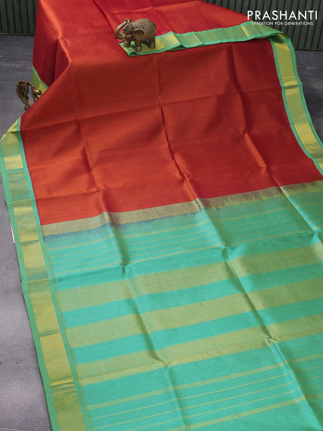 Silk cotton saree rust shade and teal green with plain body and zari woven korvai border