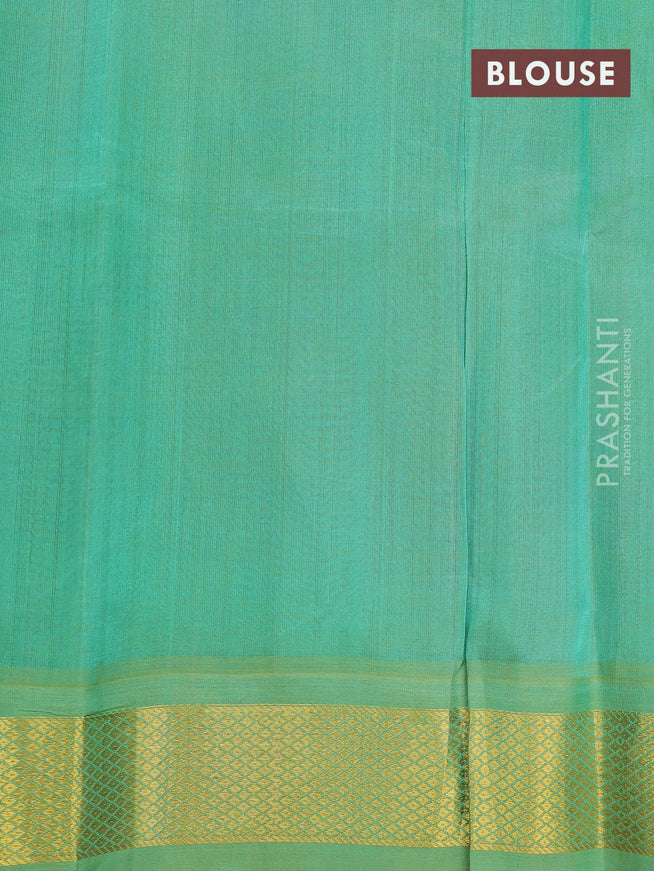 Silk cotton saree rust shade and teal green with plain body and zari woven korvai border