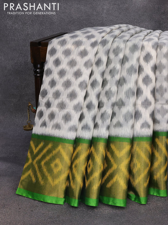 Ikat silk cotton saree off white and light green with allover ikat weaves and long ikat woven border