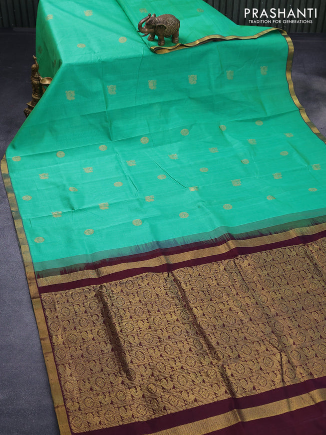 Silk cotton saree teal green and deep jamun shade with annam zari woven buttas and zari woven border