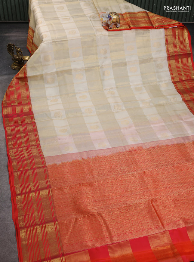 Pure kanchipuram silk saree cream and orange with allover zari checks & buttas and rich zari woven korvai border