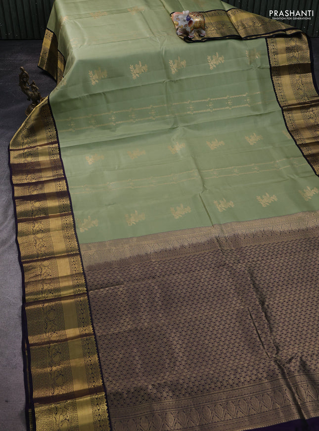 Pure kanchipuram silk saree pastel green and black with allover zari weaves & buttas and long zari woven korvai border