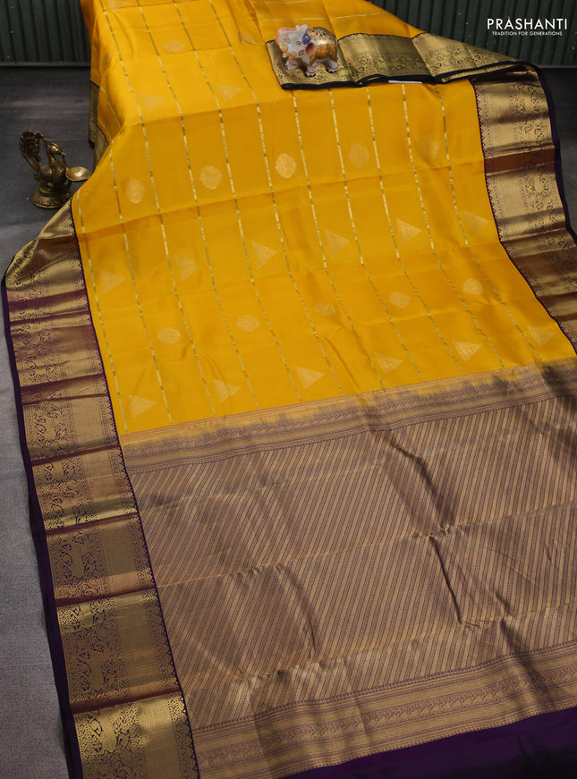 Pure kanchipuram silk saree yellow and deep purple with allover zari weaves & buttas and rich zari woven korvai border