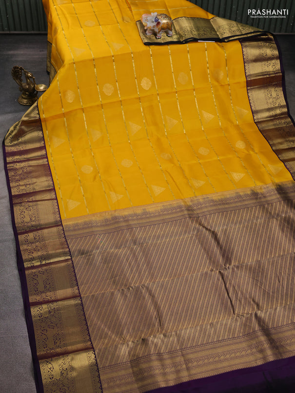Pure kanchipuram silk saree yellow and deep purple with allover zari weaves & buttas and rich zari woven korvai border