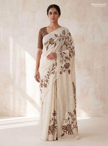 Semi linen tissue saree cream and deep jamun with applique work and crocia lace work border