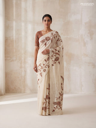 Semi linen tissue saree cream and rustic orange with applique work and crocia lace work border