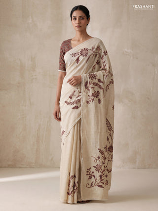 Semi linen tissue saree cream and wine shade with applique work and crocia lace work border
