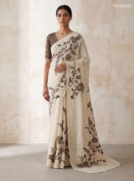 Semi linen tissue saree cream and black with applique work and crocia lace work border