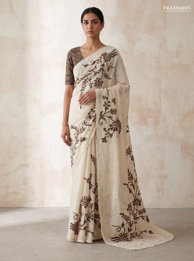 Semi linen tissue saree cream and black with applique work and crocia lace work border