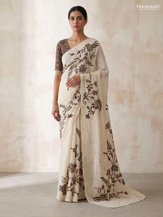 Semi linen tissue saree cream and black with applique work and crocia lace work border