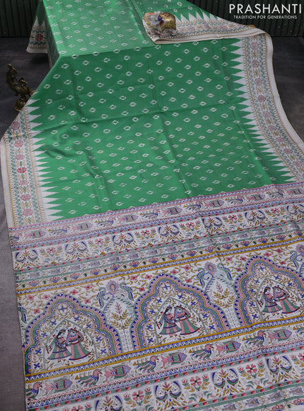 Pochampally silk saree light green and cream with allover ikat woven buttas and madhubani prints